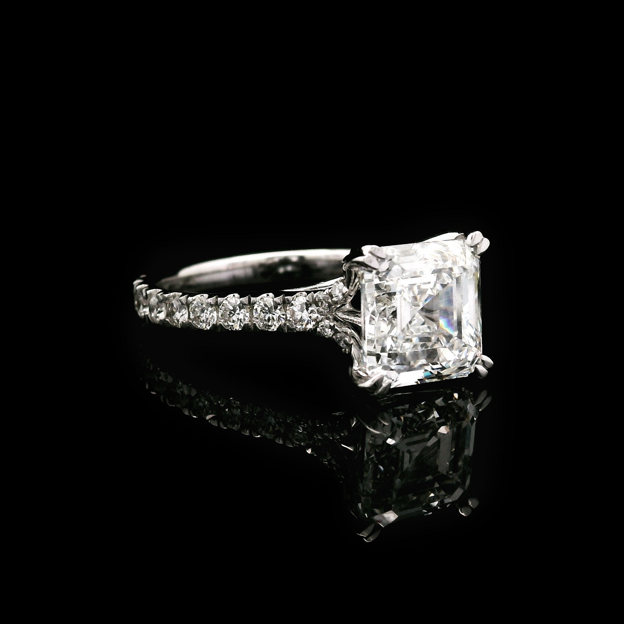 Diamond engagement ring with 3 carat Asscher cut center stone on a black background left side